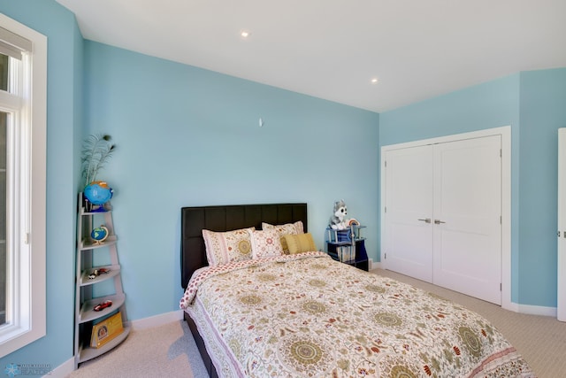 carpeted bedroom with a closet