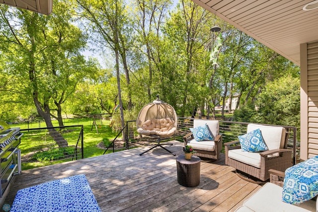 wooden terrace featuring an outdoor living space and a yard