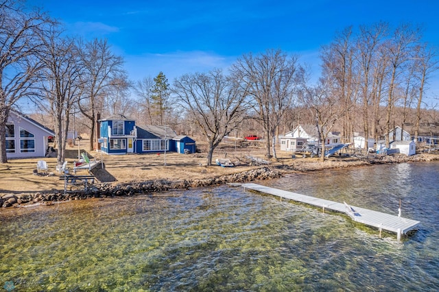 view of yard with a dock and a water view