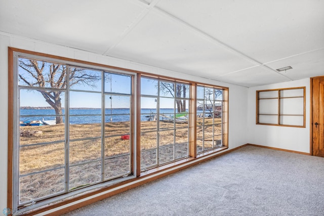 unfurnished sunroom with a water view and a healthy amount of sunlight