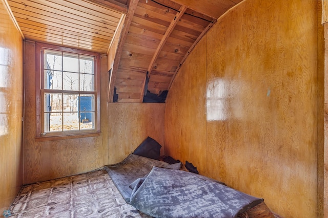 spare room with wood walls, wooden ceiling, and lofted ceiling