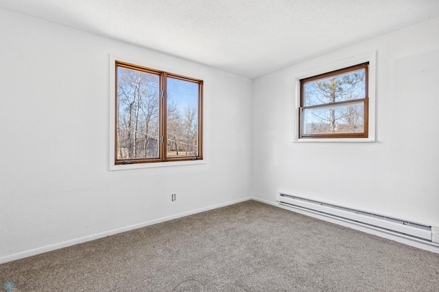 carpeted spare room with a baseboard radiator and a textured ceiling