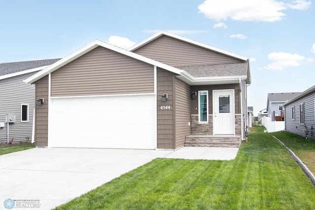 view of front of home with a garage and a front lawn