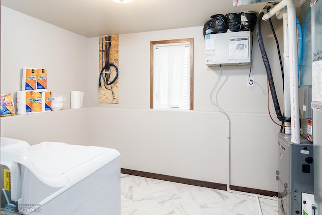 clothes washing area with light tile flooring and washer and dryer