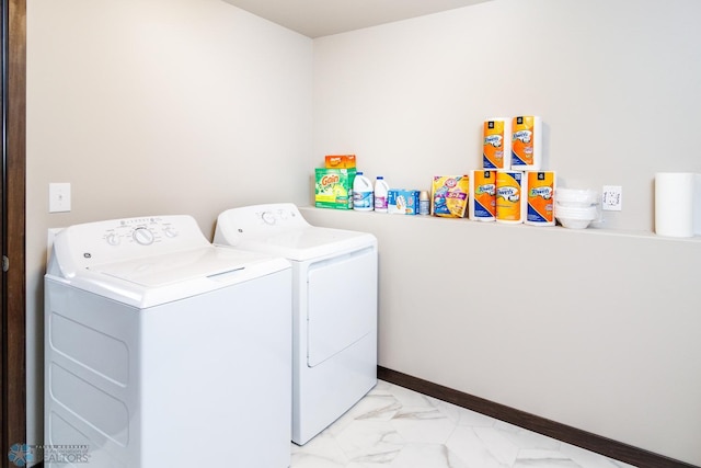 laundry area featuring washer and dryer and light tile floors