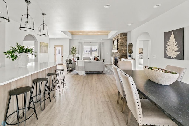 dining space featuring a fireplace and light hardwood / wood-style floors