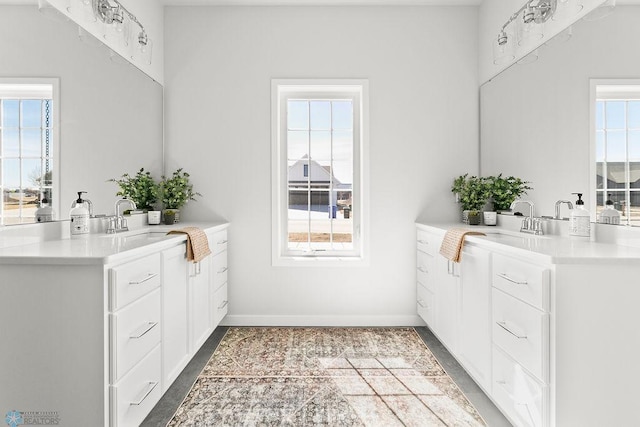 bathroom with a wealth of natural light, oversized vanity, and tile flooring