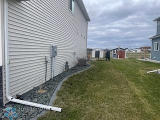 view of side of property featuring central air condition unit