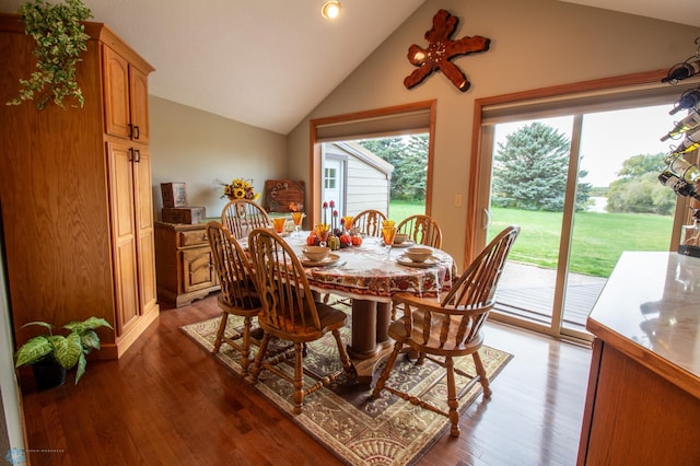 dining room featuring wood-type flooring and vaulted ceiling