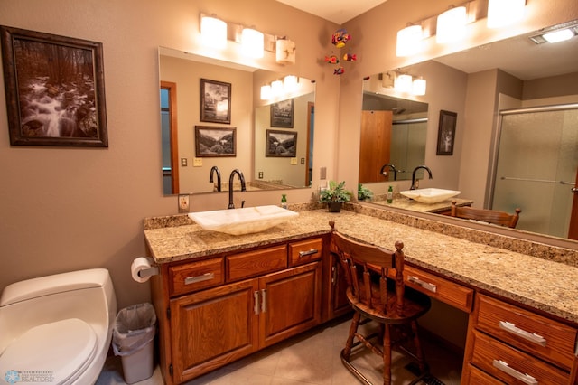 bathroom with tile floors, oversized vanity, and toilet