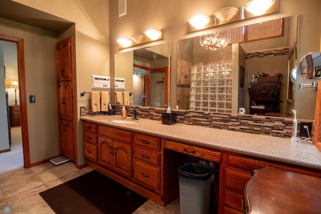 bathroom with a notable chandelier, backsplash, vanity, and tile floors