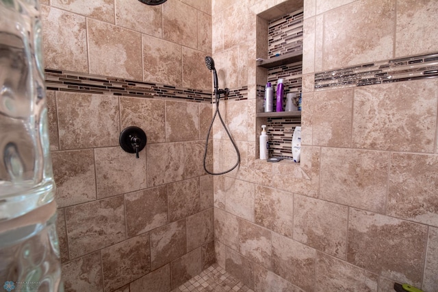 bathroom with a tile shower