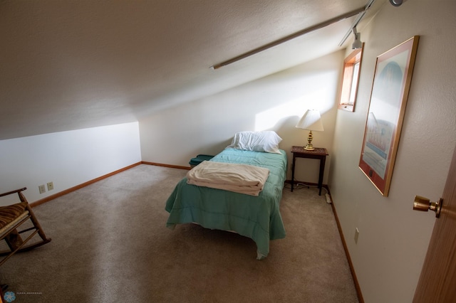 unfurnished bedroom with carpet and lofted ceiling