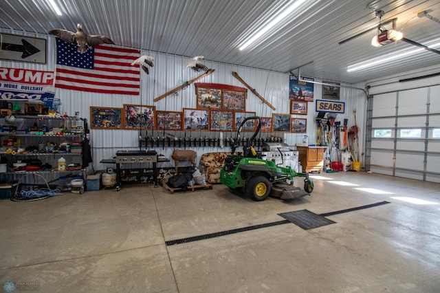 garage with a garage door opener and a workshop area