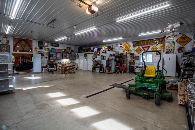 garage with ceiling fan and a workshop area