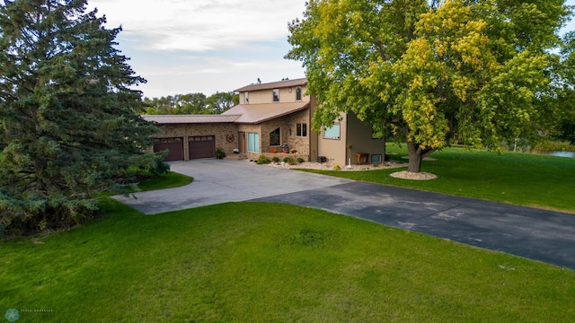 view of front of home with a garage and a front lawn