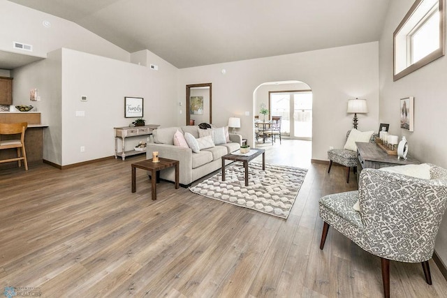 living room featuring hardwood / wood-style flooring and vaulted ceiling