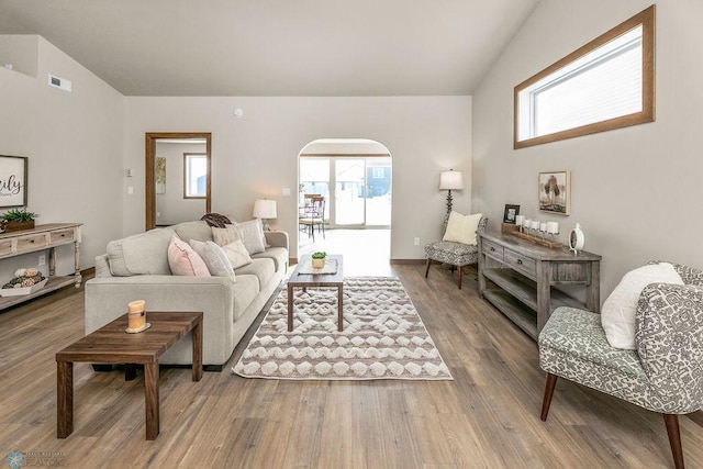 living room with vaulted ceiling and hardwood / wood-style floors