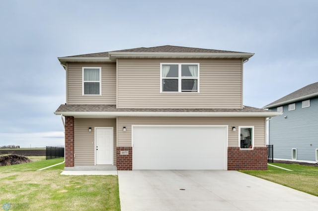 view of front of house featuring a front yard and a garage