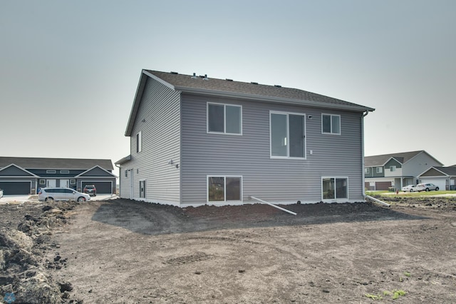 back of property featuring a garage