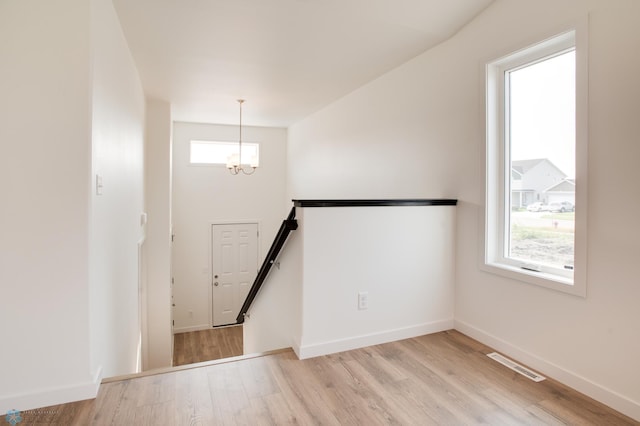 entryway with a notable chandelier and light hardwood / wood-style flooring