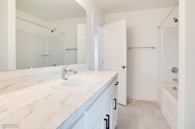 bathroom featuring tile patterned flooring, shower / tub combination, and vanity