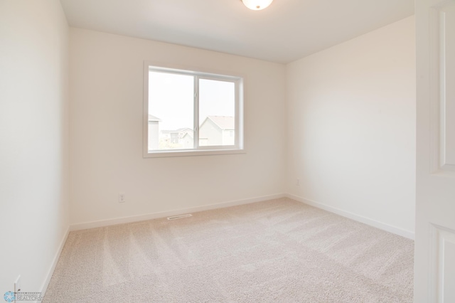 unfurnished room with light carpet