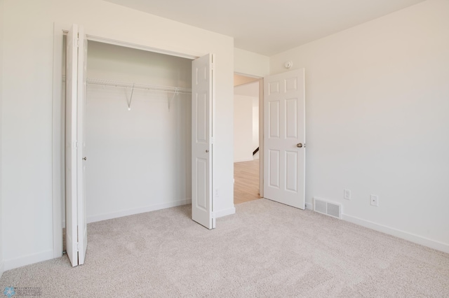 unfurnished bedroom featuring carpet floors and a closet