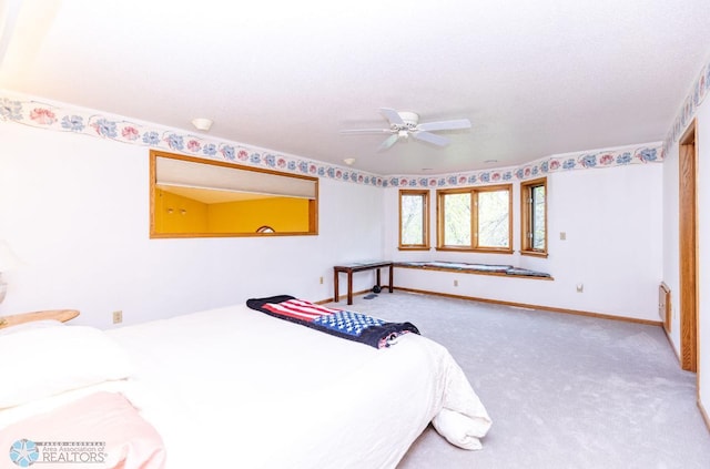 bedroom with carpet, ceiling fan, and a textured ceiling