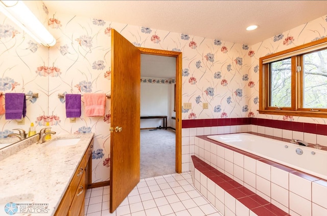 bathroom with a relaxing tiled bath, tile flooring, a textured ceiling, and oversized vanity