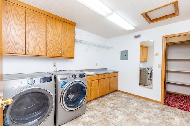 clothes washing area featuring cabinets, sink, washer and clothes dryer, and light tile floors