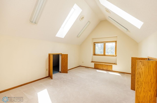 bonus room featuring carpet flooring and lofted ceiling with skylight