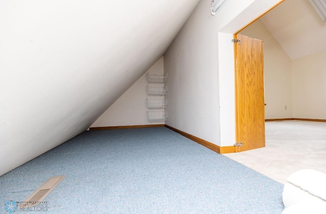 bonus room featuring carpet floors and lofted ceiling