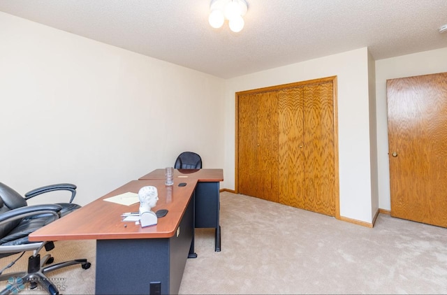 office area with light carpet and a textured ceiling