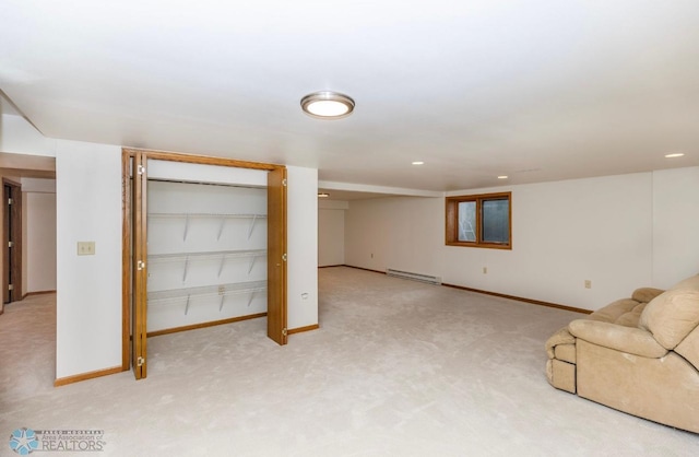 basement with baseboard heating and carpet