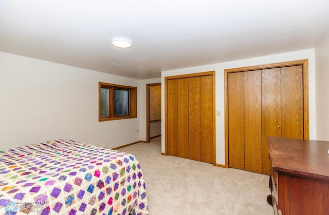 carpeted bedroom with multiple closets