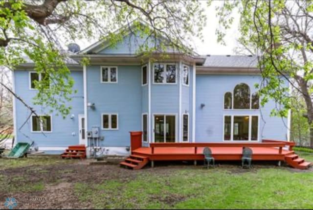 back of house featuring a wooden deck