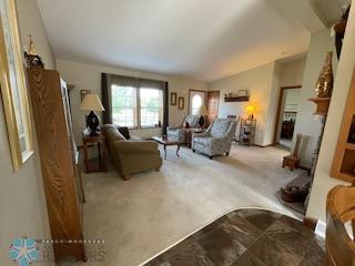 carpeted living room featuring lofted ceiling