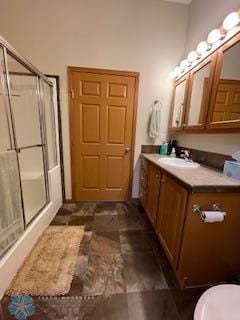 bathroom with toilet, vanity, an enclosed shower, and tile floors