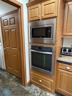 kitchen featuring appliances with stainless steel finishes and dark tile floors