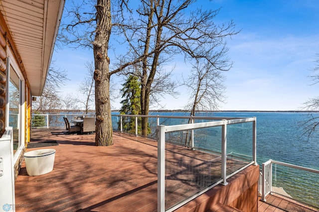 wooden terrace featuring a water view