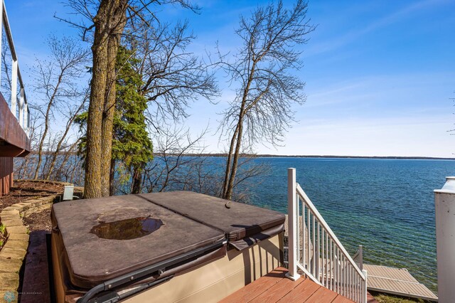 exterior space featuring a hot tub and a water view