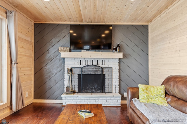 unfurnished living room with wooden walls, dark hardwood / wood-style flooring, wood ceiling, and a brick fireplace