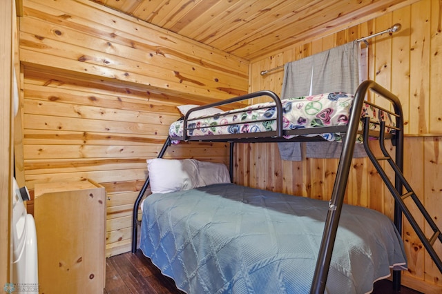 bedroom with wooden ceiling, hardwood / wood-style flooring, and wooden walls