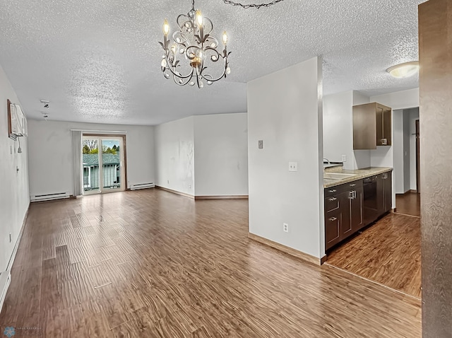 unfurnished living room featuring a baseboard radiator, a textured ceiling, hardwood / wood-style floors, and a chandelier