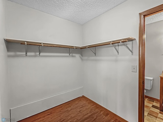 spacious closet with light tile patterned floors