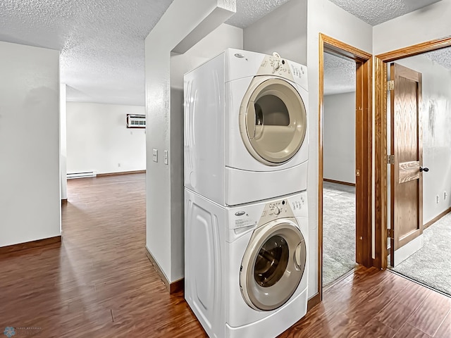 washroom with stacked washing maching and dryer, dark colored carpet, a wall mounted AC, and a textured ceiling