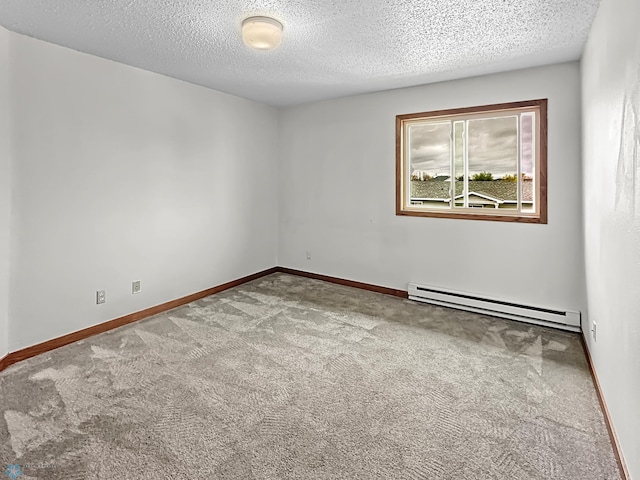 spare room with a textured ceiling, a baseboard heating unit, and carpet flooring