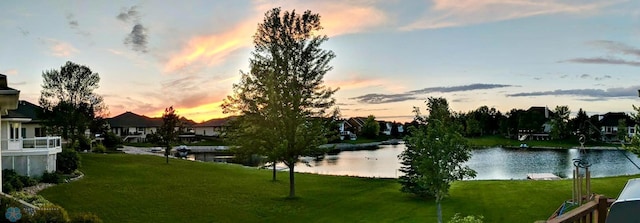 surrounding community featuring a yard and a water view