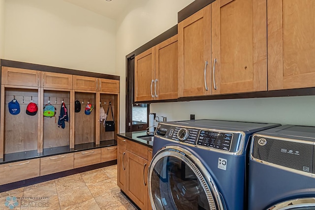 laundry room with cabinets, separate washer and dryer, and light tile floors